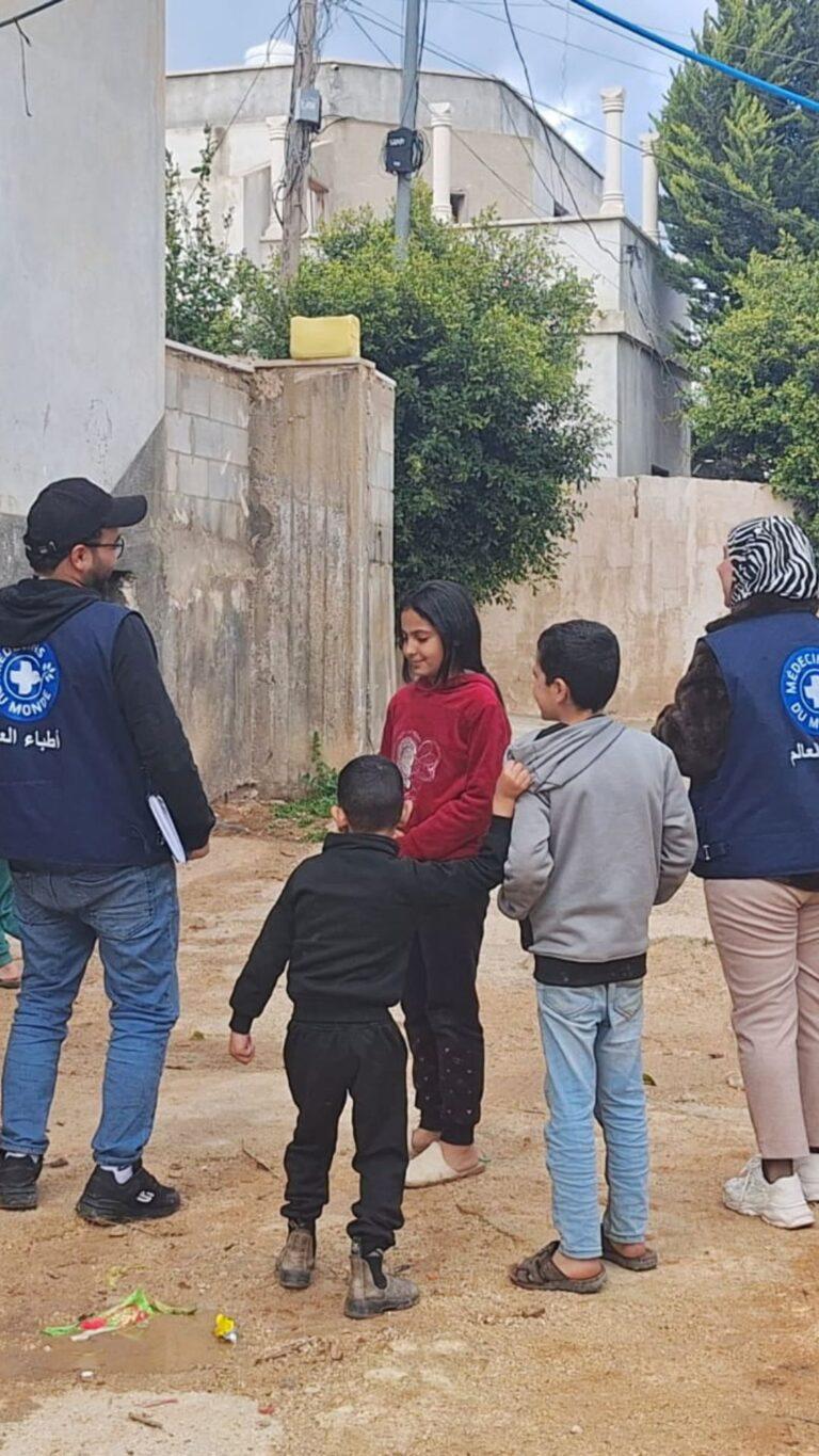 Burqin, West Bank - Feb 2025 Two MdM staff members are discussing with a group of children outside in Burqin. They are Palestinian refugees / displaced people from Jenin camp. Their families struggle daily as they continue to face displacement, insecurity, and uncertainty amid escalating violence. Families who have lost their homes and livelihoods are forced to seek shelter in overcrowded conditions, carrying the weight of trauma and fear. Despite these harsh realities, their resilience and dignity remain evident, especially in the determination of parents to protect their children and rebuild some sense of normalcy.